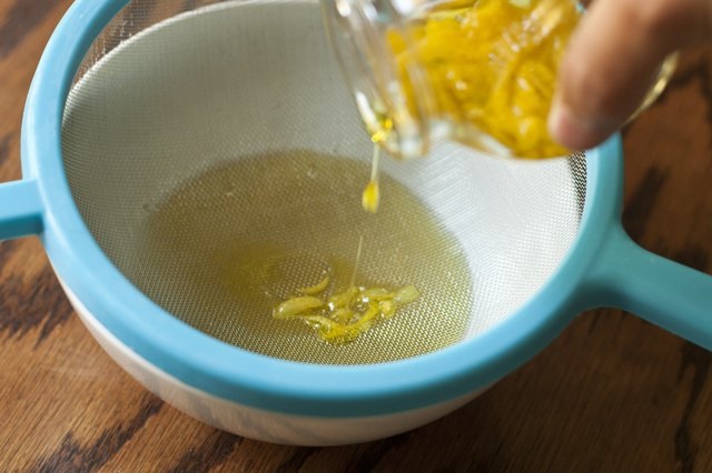 Filtrez le mélange à travers une passoire ou un tamis de manière à séparer l'huile et les zestes